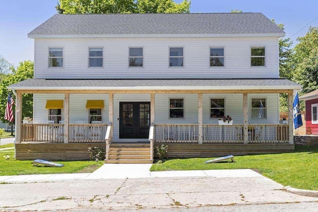 401 Antrim St, Charlevoix, MI 49720 - view of front of home featuring a porch and roof with shingles