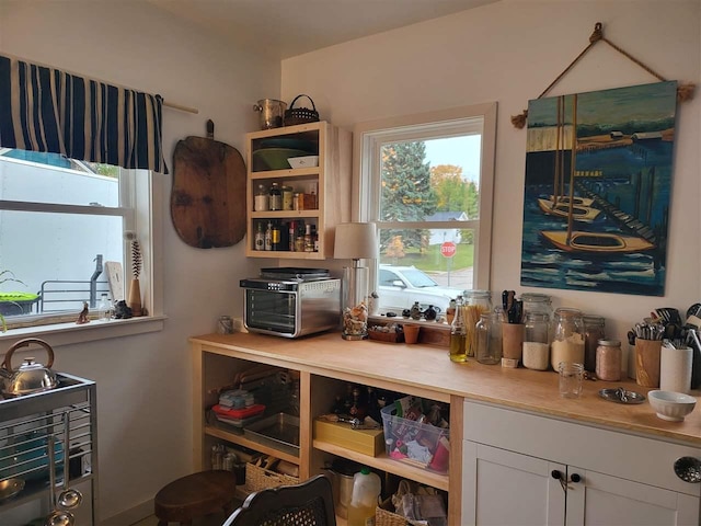 401 Antrim St, Charlevoix, MI 49720 - kitchen featuring white cabinets, light countertops, and open shelves