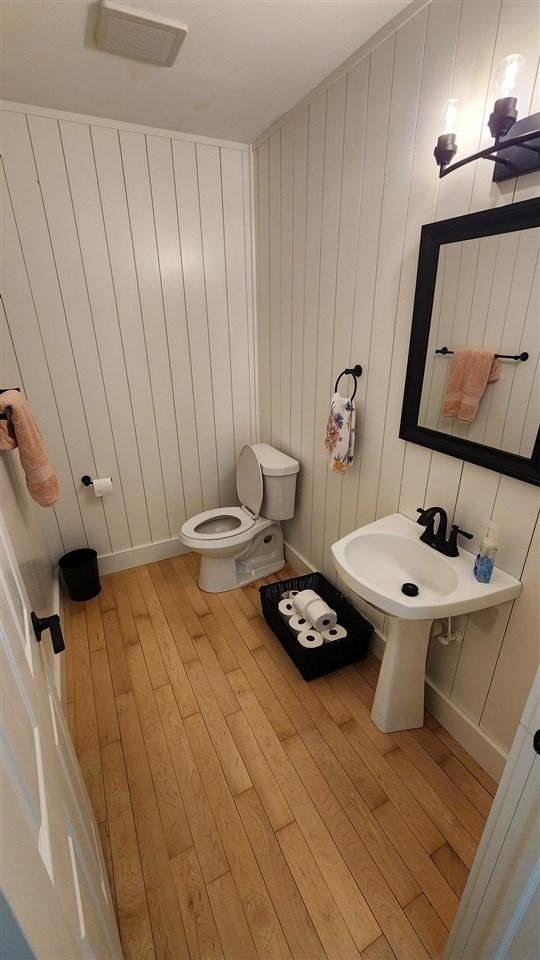 bathroom featuring toilet and hardwood / wood-style floors