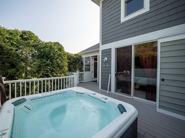 view of pool featuring a hot tub and a deck