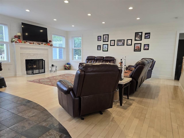 living room with a premium fireplace and light wood-type flooring