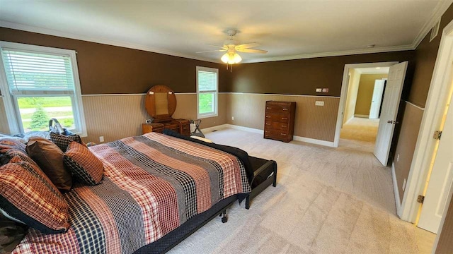 bedroom with ceiling fan, light colored carpet, and ornamental molding