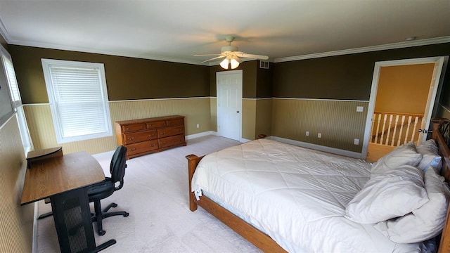 bedroom with crown molding, light colored carpet, and ceiling fan