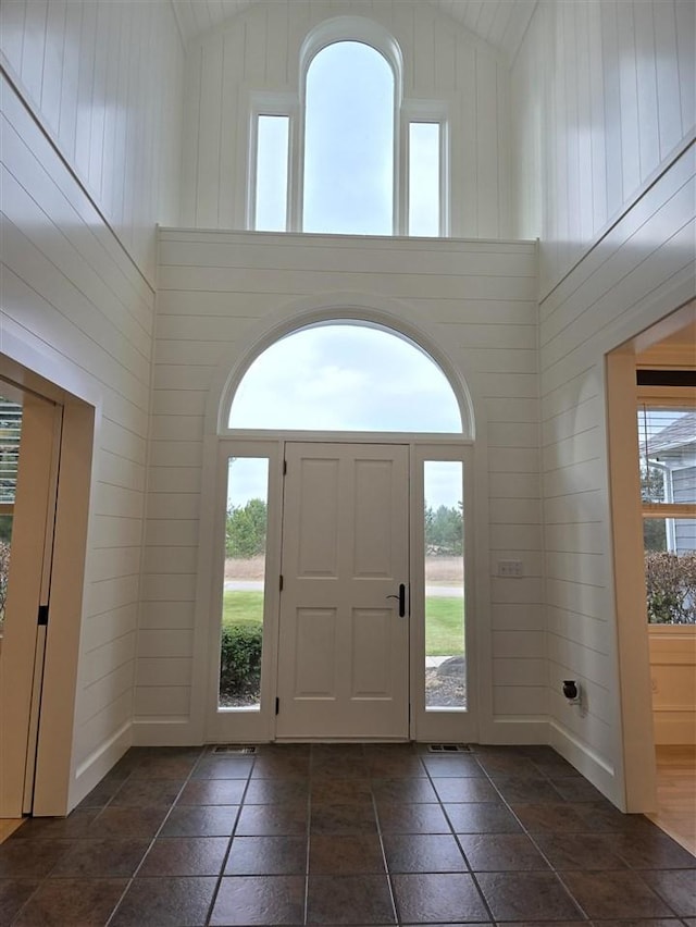 entrance foyer featuring high vaulted ceiling