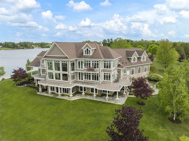 1439 Lindburgh Ln, Cheboygan, MI 49721 - rear view of property with a lawn, a water view, and a sunroom