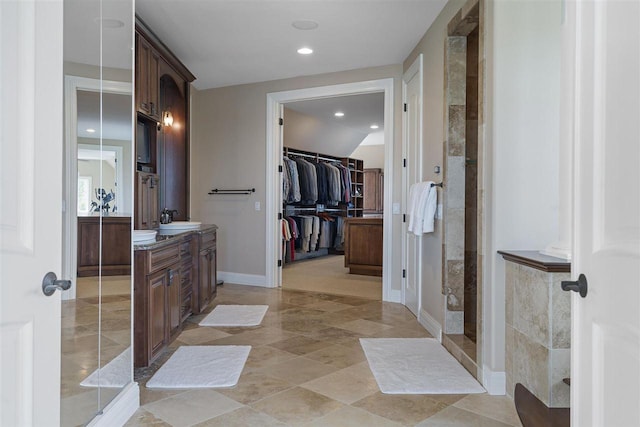 1439 Lindburgh Ln, Cheboygan, MI 49721 - full bath featuring vanity, tiled shower, a walk in closet, recessed lighting, and tile patterned floors