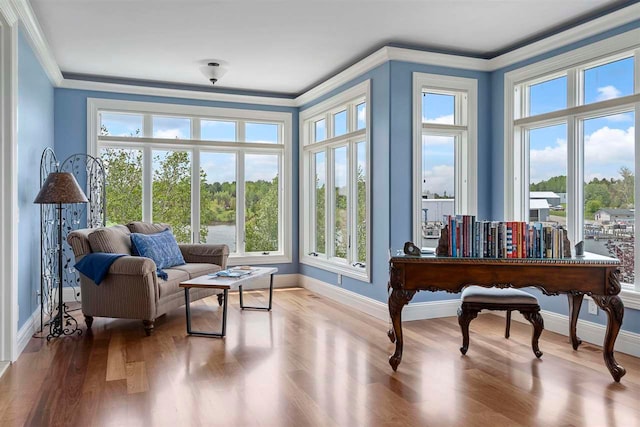 sitting room with hardwood / wood-style flooring and ornamental molding