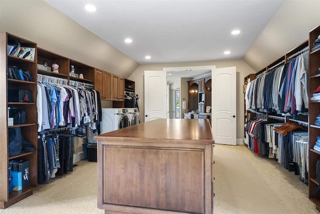 1439 Lindburgh Ln, Cheboygan, MI 49721 - walk in closet featuring washer and clothes dryer, light colored carpet, and vaulted ceiling