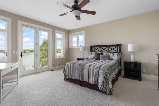1439 Lindburgh Ln, Cheboygan, MI 49721 - bedroom featuring access to outside, carpet, and a ceiling fan