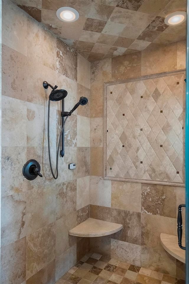 bathroom featuring tiled shower and tile walls