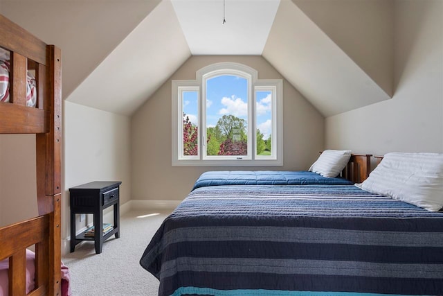 bedroom featuring lofted ceiling and carpet