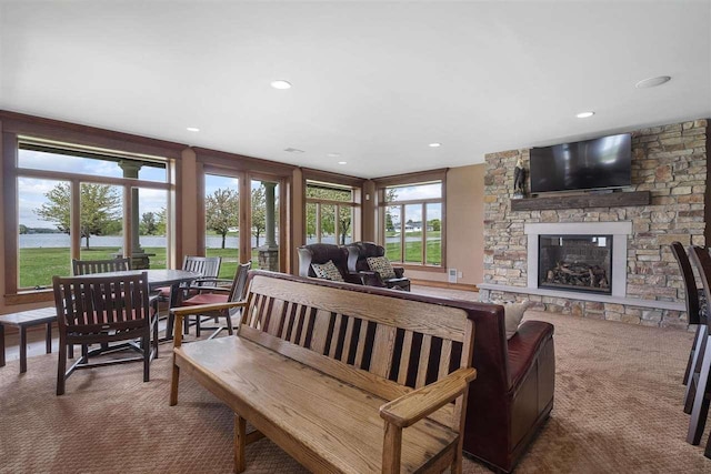 1439 Lindburgh Ln, Cheboygan, MI 49721 - living room featuring carpet flooring, a fireplace, a water view, and recessed lighting