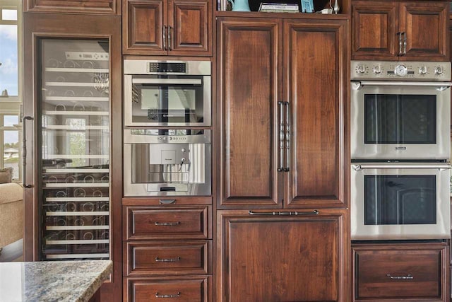 1439 Lindburgh Ln, Cheboygan, MI 49721 - kitchen featuring double oven and stone counters