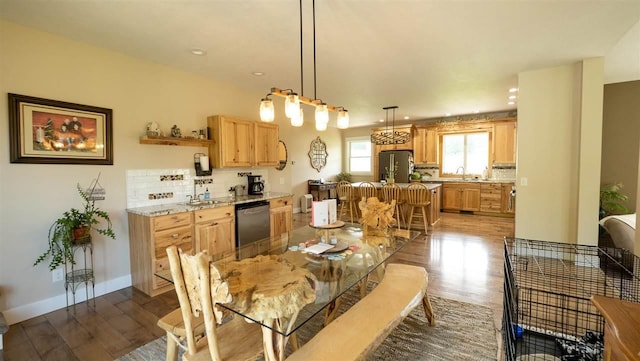 dining area with sink and wood-type flooring