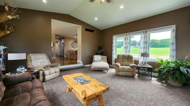 living room featuring carpet floors, lofted ceiling, and ceiling fan