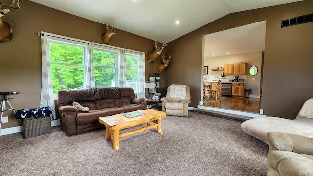 living room with lofted ceiling and carpet flooring