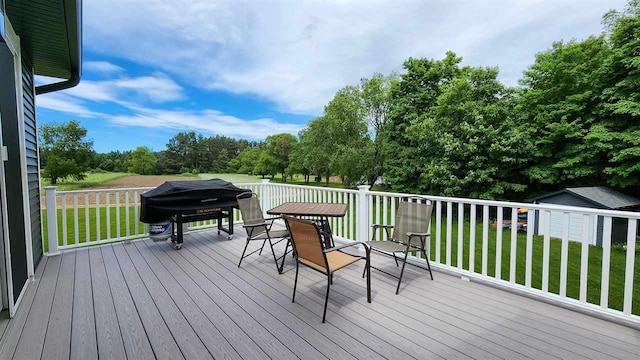 deck with a lawn and grilling area