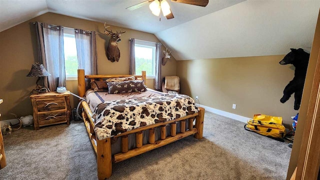 carpeted bedroom featuring ceiling fan, multiple windows, and lofted ceiling