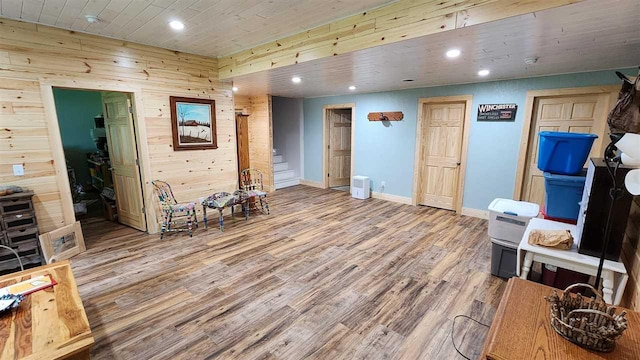 interior space featuring light hardwood / wood-style flooring and wood walls