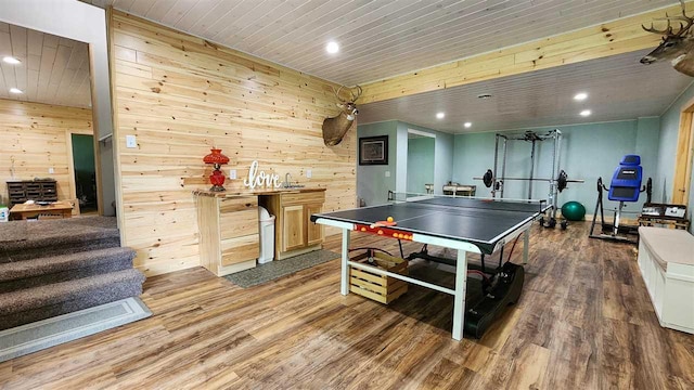 playroom with hardwood / wood-style flooring and wood walls