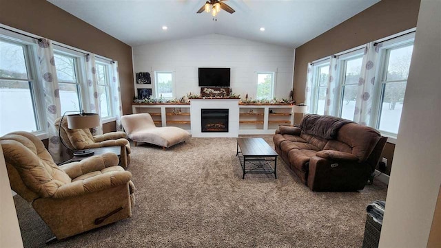 carpeted living room featuring vaulted ceiling and ceiling fan