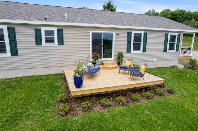 back of house with a wooden deck and a lawn