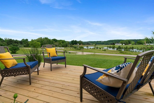 wooden deck featuring a water view and a yard