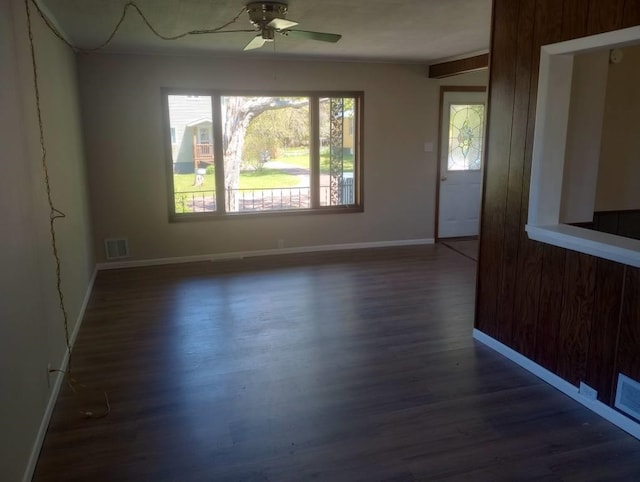 spare room with ceiling fan and dark hardwood / wood-style flooring