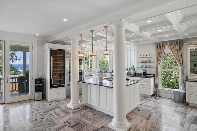 kitchen with coffered ceiling, crown molding, hanging light fixtures, beamed ceiling, and white cabinetry