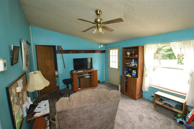 living room featuring ceiling fan, light colored carpet, lofted ceiling, and a textured ceiling