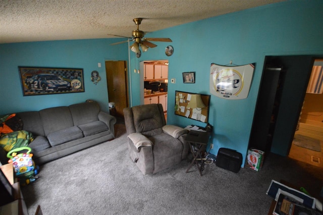 carpeted living room featuring ceiling fan and a textured ceiling