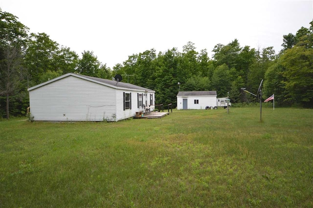 view of yard with an outbuilding and a deck