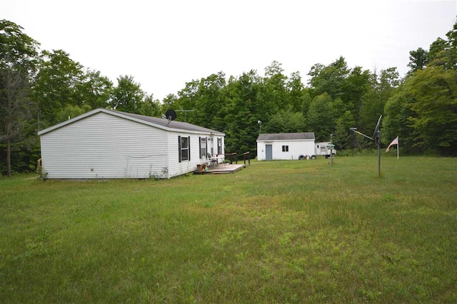 view of yard featuring a wooden deck and an outdoor structure