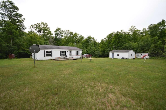 view of yard featuring an outdoor structure and a deck