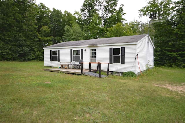 back of house with a deck and a lawn