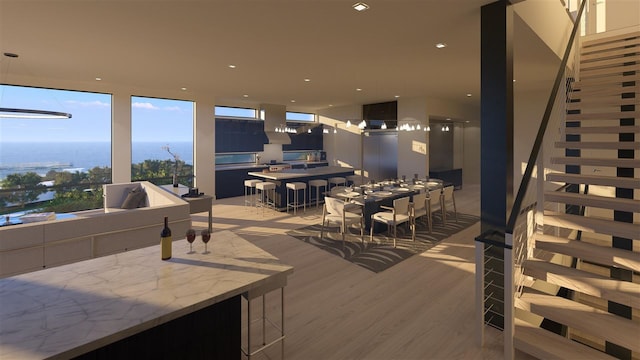 living room featuring elevator, a water view, and light hardwood / wood-style floors