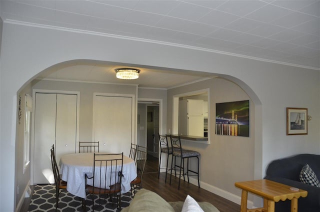 2690 E Lake St, Harbor Springs, MI 49740 - dining area with ornamental molding and dark hardwood / wood-style flooring