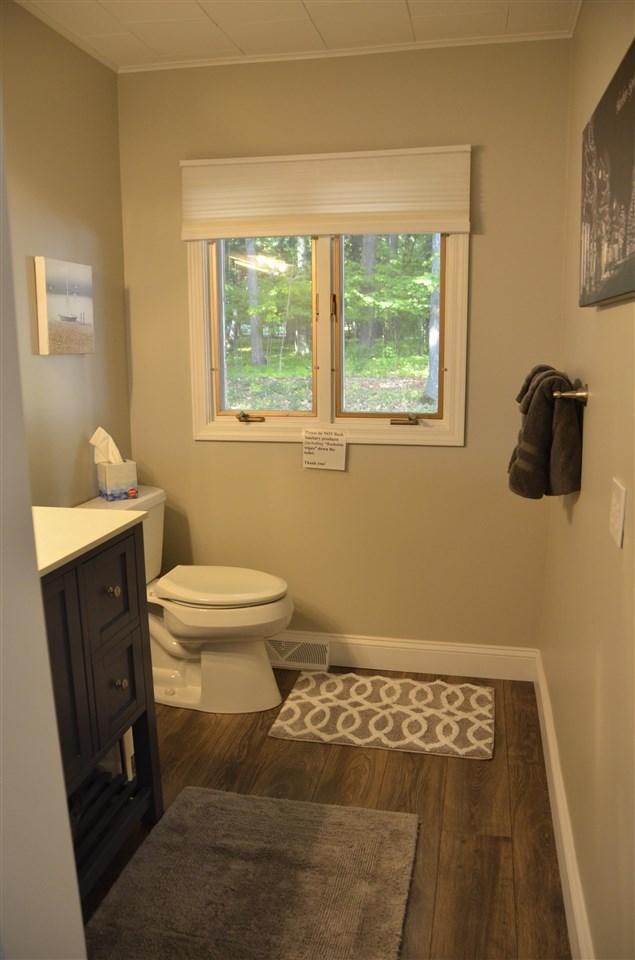 2690 E Lake St, Harbor Springs, MI 49740 - bathroom featuring wood-type flooring, vanity, crown molding, and toilet