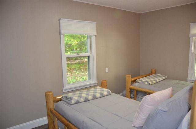 2690 E Lake St, Harbor Springs, MI 49740 - bedroom with multiple windows, hardwood / wood-style floors, and crown molding