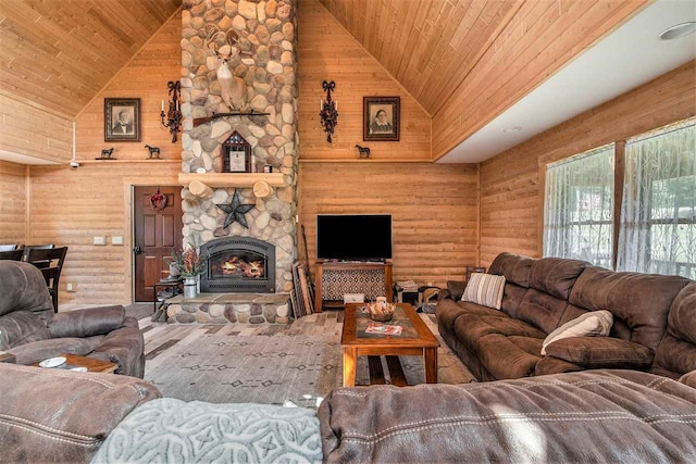 living room with a fireplace, high vaulted ceiling, and wooden ceiling