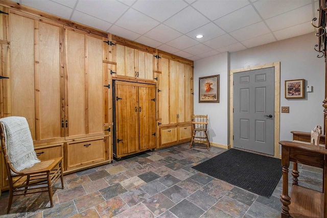 tiled foyer entrance with a drop ceiling