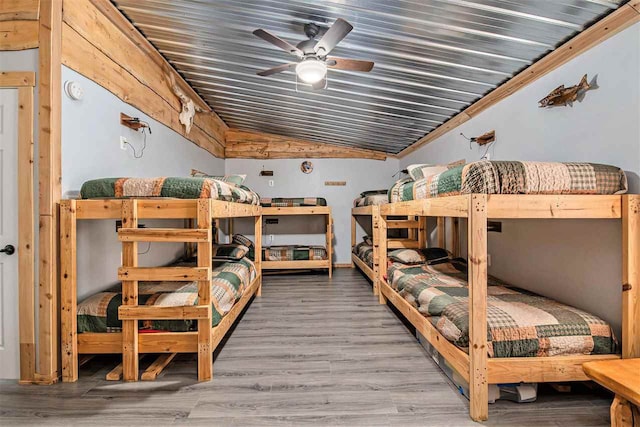 bedroom with lofted ceiling, wood-type flooring, and ceiling fan