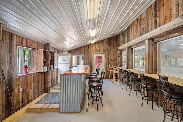 interior space featuring wooden walls and vaulted ceiling