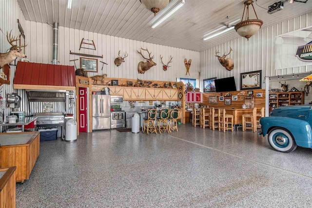 garage featuring stainless steel refrigerator