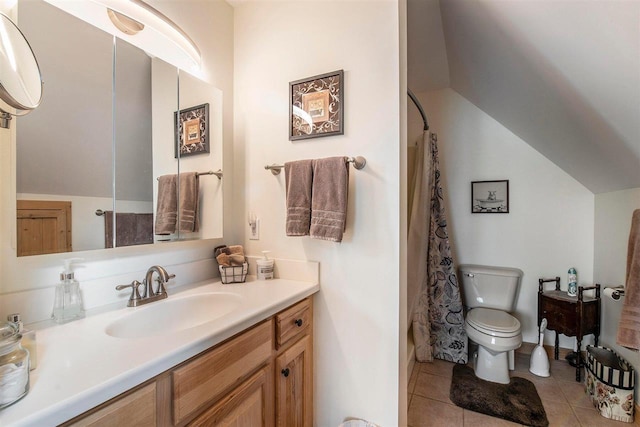 bathroom with vanity, toilet, tile patterned floors, and vaulted ceiling