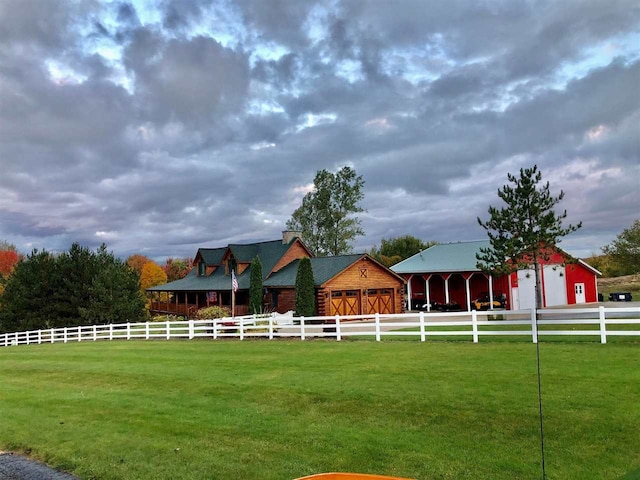 view of yard with an outdoor structure and a rural view