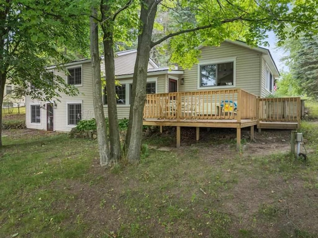 rear view of property featuring a deck