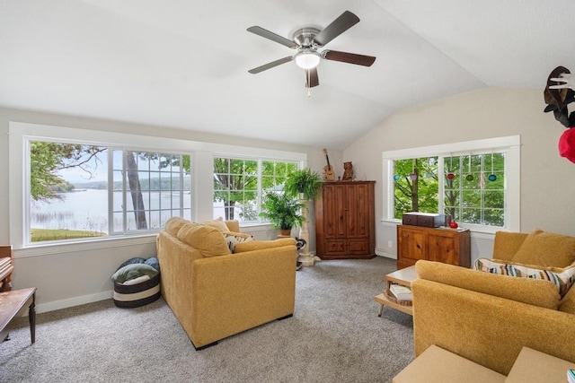 carpeted living room featuring a water view, lofted ceiling, and ceiling fan