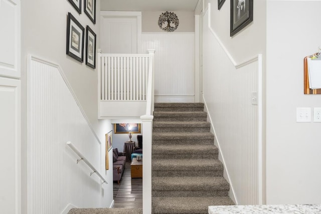 stairway with hardwood / wood-style flooring