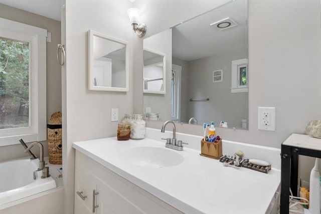 bathroom with vanity and a tub to relax in